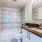 shower/tub combo in well-lit bathroom