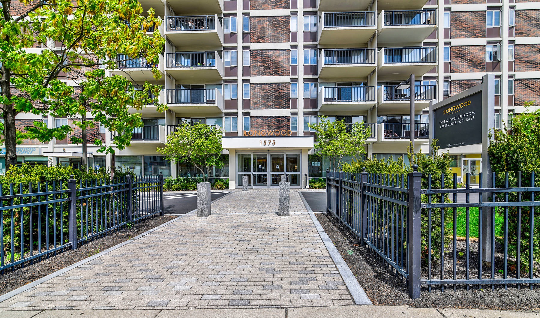 Welcome Home to The Longwood lobby wall with property name and cushioned bench